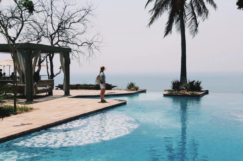 A woman stands at an infinity pool overlooking Lake Kariba, showing how safe are safari tours when every property is carefully vetted.