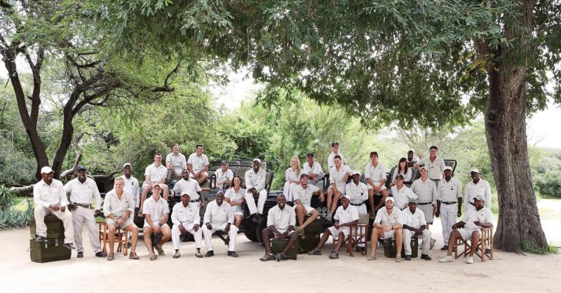 Group photo of Londolozi’s rangers and trackers gathered under a tree in the Sabi Sand