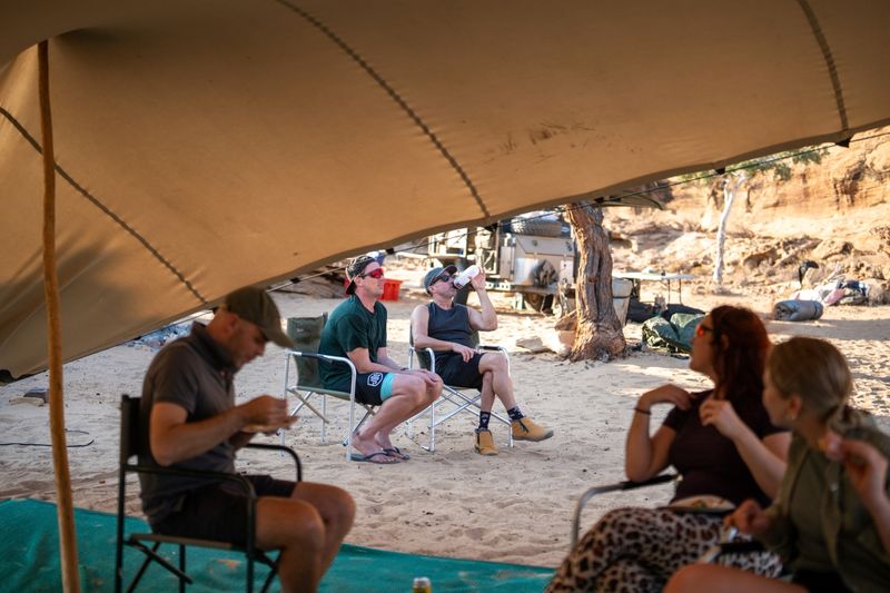 Riders relaxing and talking under the canopy