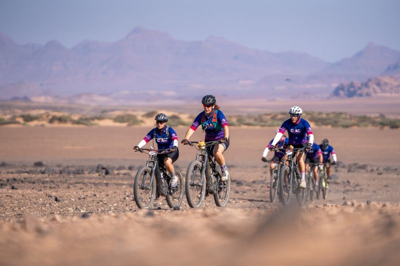 Riders cycling in the desert