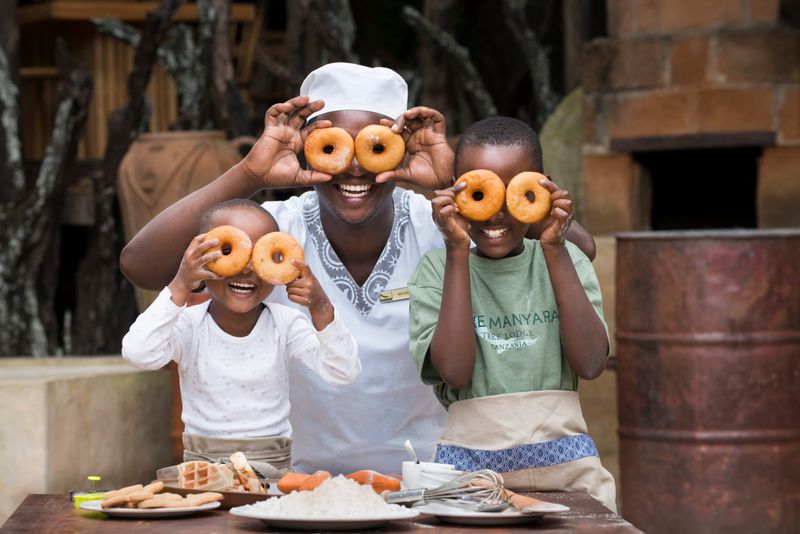 Children working with chef at Lake Manyara Tree Lodge