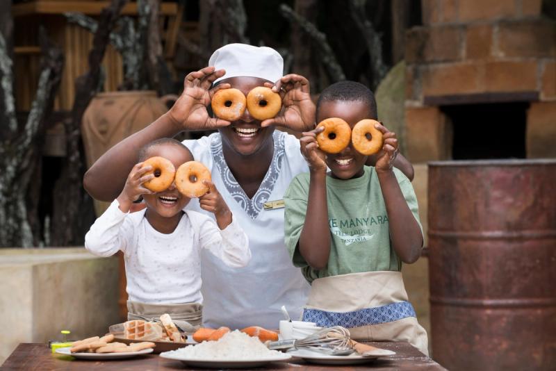 Children working with chef at Lake Manyara Tree Lodge