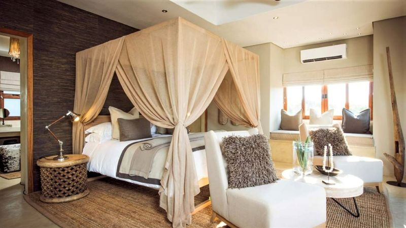 King sized draped four-poster bed leads onto an en-suite bathroom