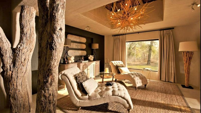 Lounge area with two reclining chairs and elaborate stick chandelier 