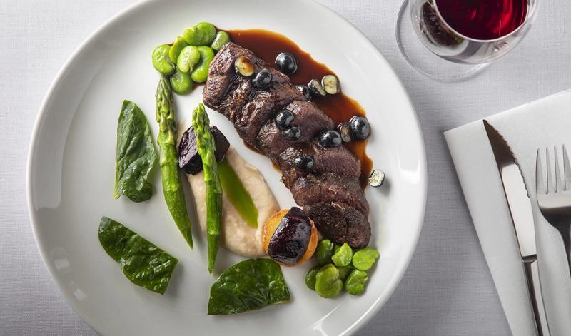 Beautifully plated meat and greens for a casual dining experience