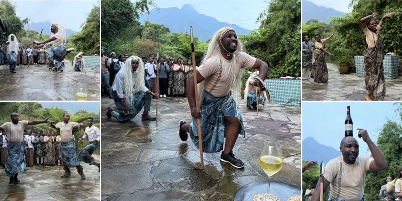 A vibrant dance performance unfolds outdoors, with Rwandan performers leaping, drumming, and even balancing a full wine bottle on one dancer’s head.