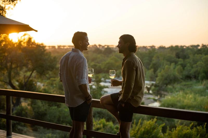 Couple of men enjoying sundowners at Londolozi