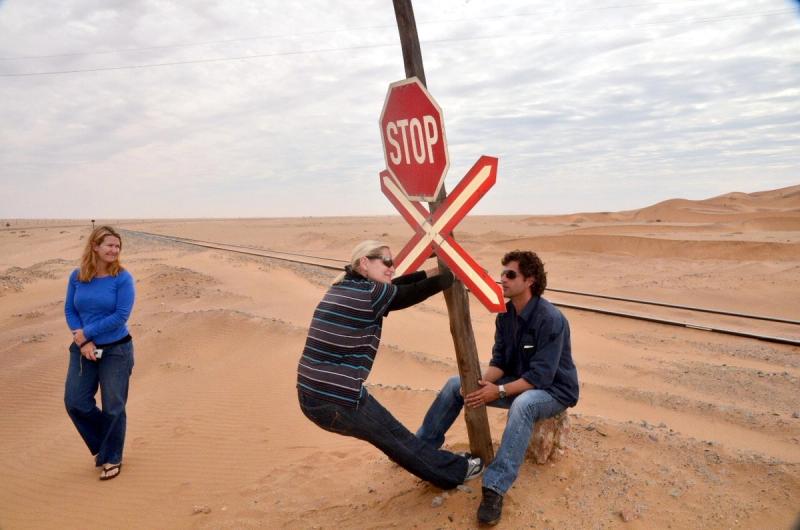 Patti Brockmann and friends in the desert playing alongside a railway line