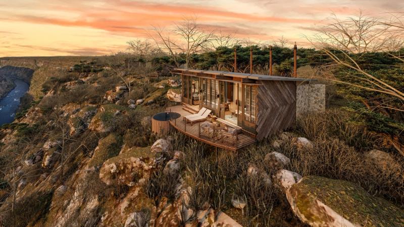 A cliffside suite with a deck, loungers, and a private hot tub perches above the Zambezi, capturing the drama surrounding the new luxury safari lodges 2026.