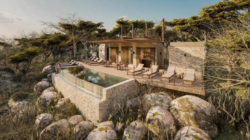 An elevated stone-and-timber pool deck sits above the bushveld with loungers, shade structures, and an infinity edge reflecting the late-afternoon light at one of the new luxury safari lodges 2026.