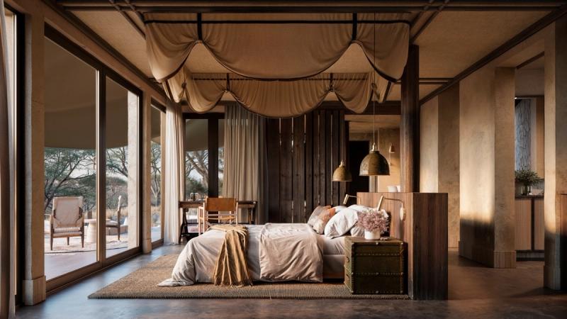 A serene, canvas-topped suite opens onto the bushveld, with soft natural light spilling across a spacious bed and warm, earthy interiors.