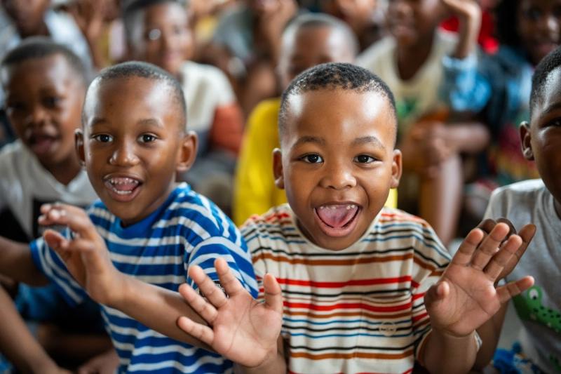 Children at the Khumbulani Christmas party waving