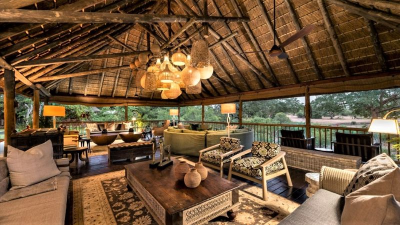 Main area adorned with African-inspired decor beneath thatch roof