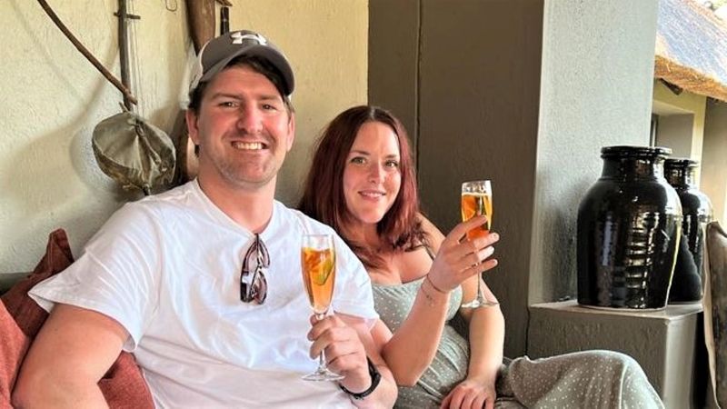 Two members of the crash seated and enjoying welcome drinks served in Champaign glasses