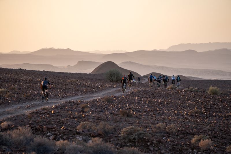 Riders cycling away from camp