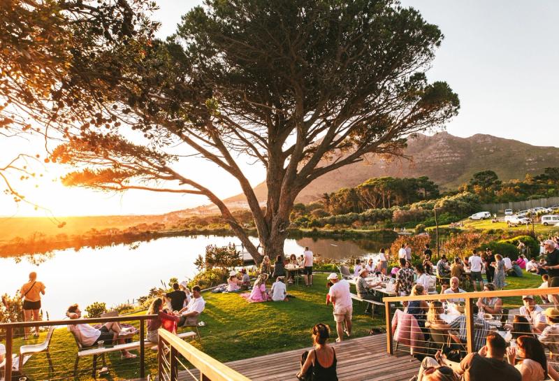 Raise your glass against the backdrop of a stunning sunset at Cape Point Vineyards