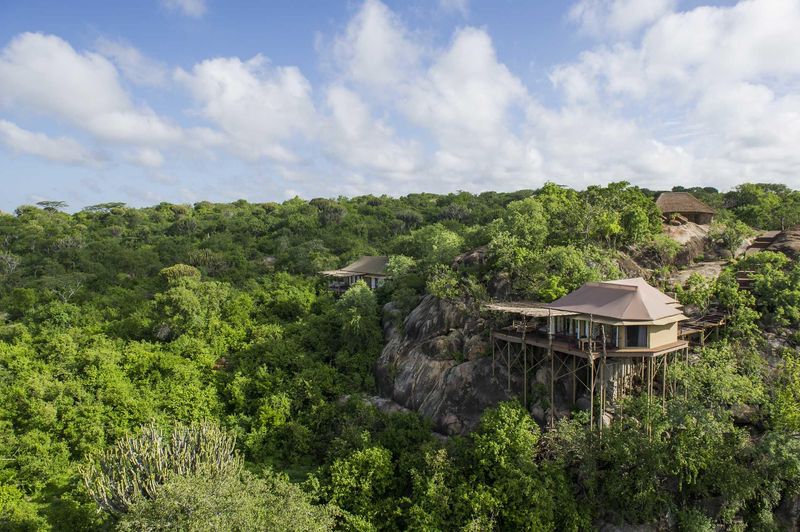 Elevated suites perched on rocky outcrops above dense greenery capture the seclusion and scale that define Luxury safari lodges in Tanzania’s southern Serengeti.