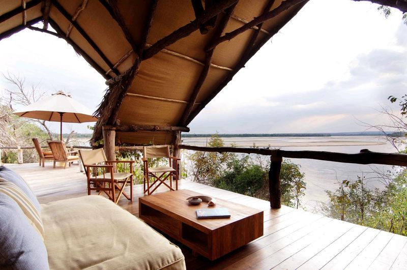 A rustic open-air lounge overlooks the Rufiji River