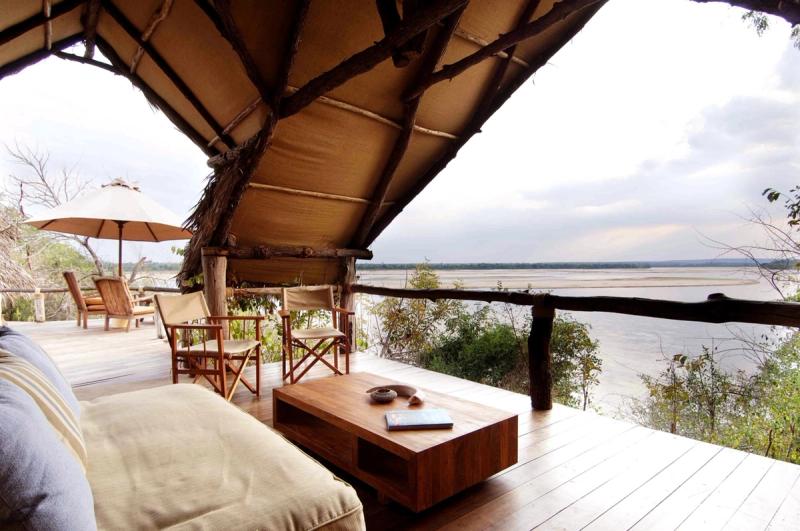 A rustic open-air lounge overlooks the Rufiji River