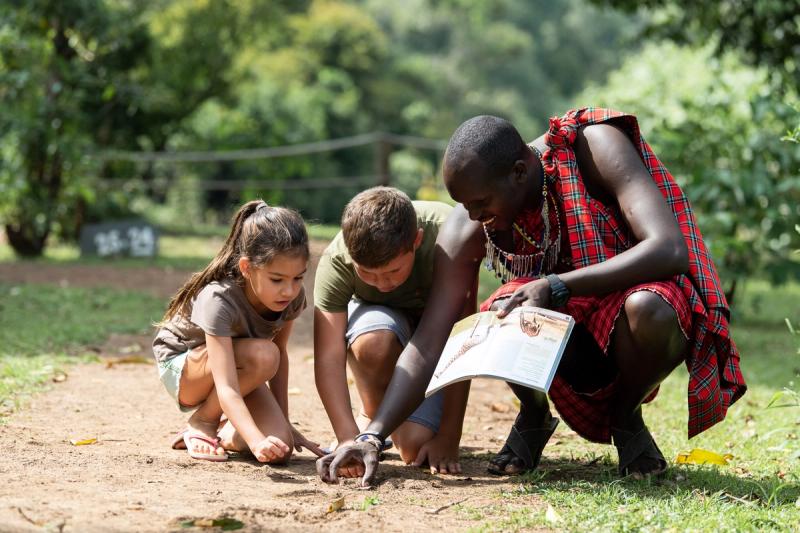 Children with Maasai showing them tracks