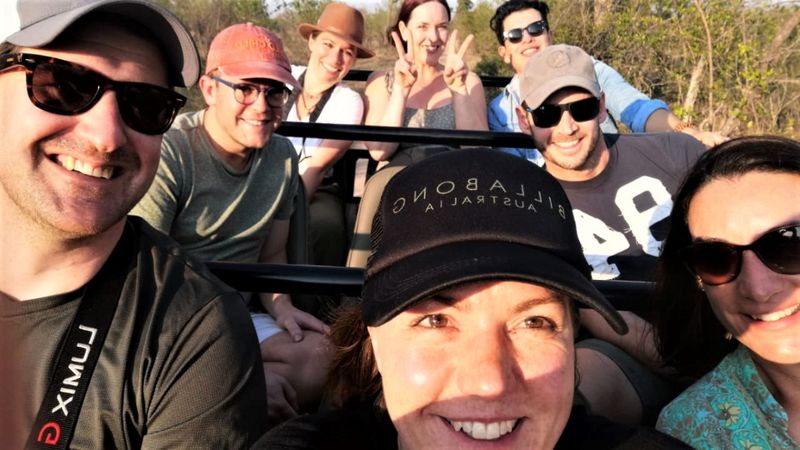 The whole rhino crash sitting and smiling on the open-game drive vehicle 