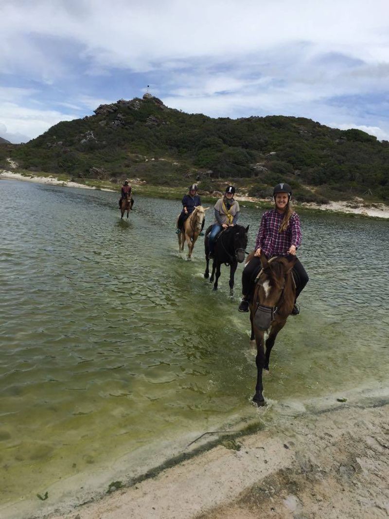 Horse riding across the lagoon to get to Noodhoek Beach