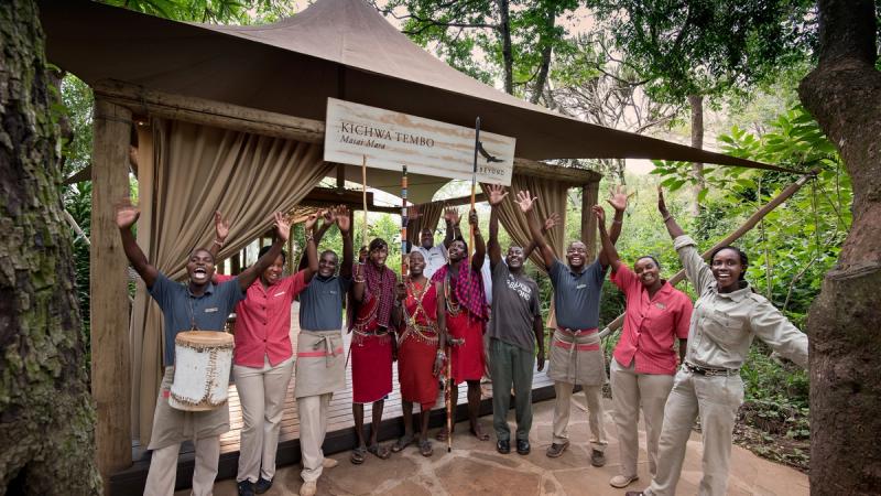 Staff at Kichwa waving at the camp's entrance