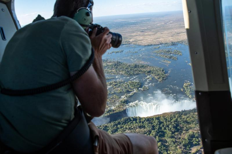 Photographer in helicopter above the Victoria Falls
