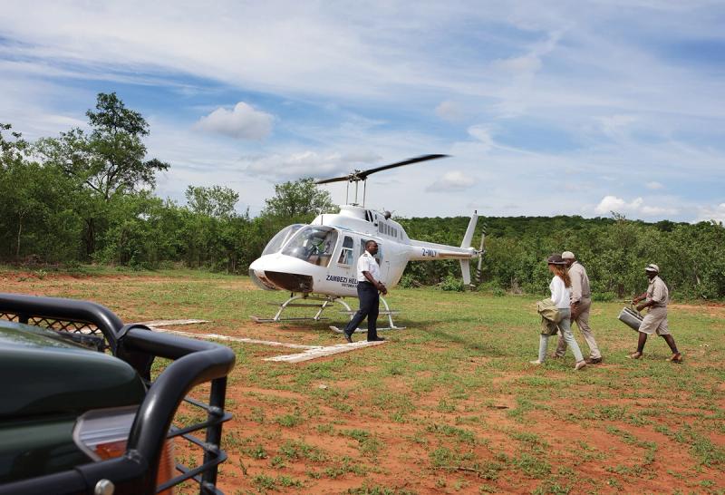 Climbing onboard a helicopter for a tour of Victoria Falls from the sky