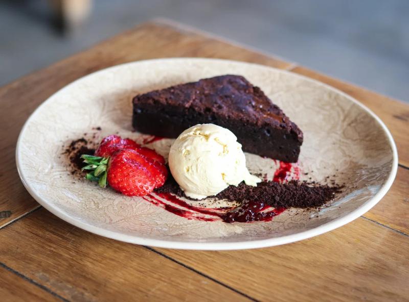 Elegantly plated chocolate brownie and ice cream dessert
