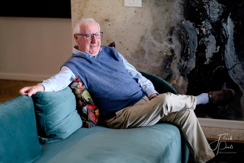 Roy Ryan leisurely sitting on a sofa at Camissa House