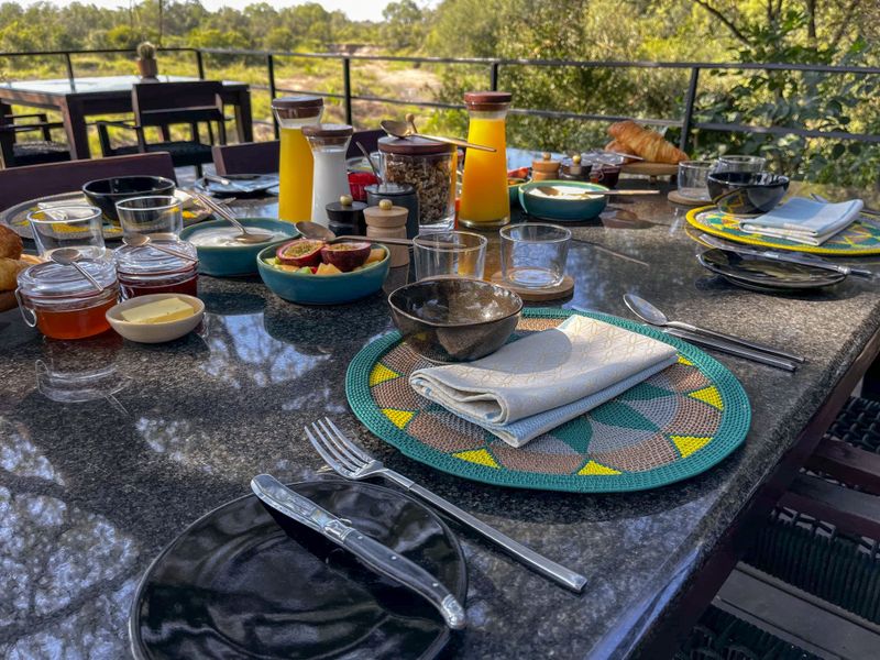 The Jackalberry tree-shrouded lower breakfast deck at Silvan Safari Lodge