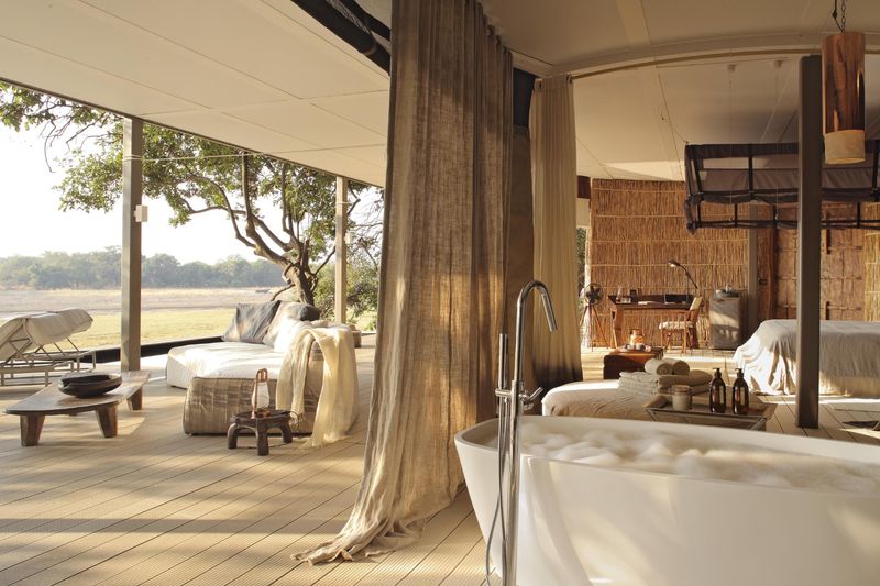 An open-plan villa with a soaking tub and river views