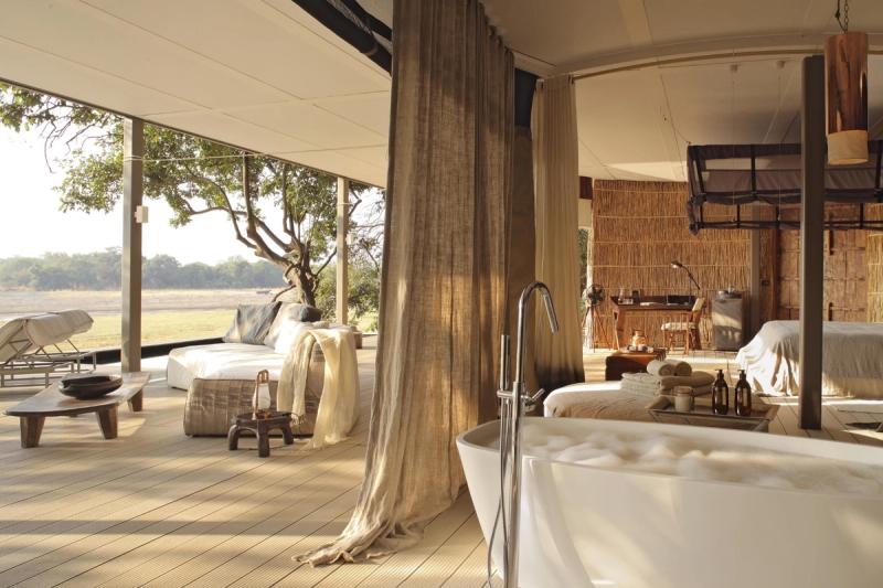 An open-plan villa with a soaking tub and river views