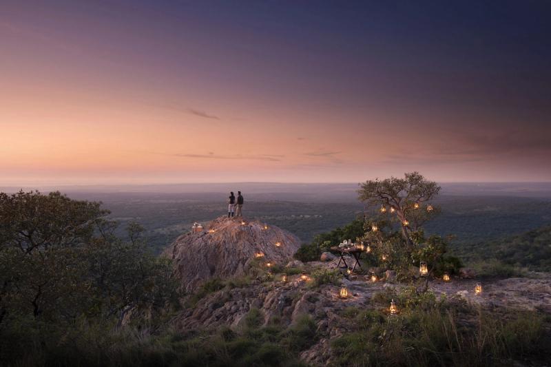 Couple on safari at sunset in Phinda Private Game Reserve