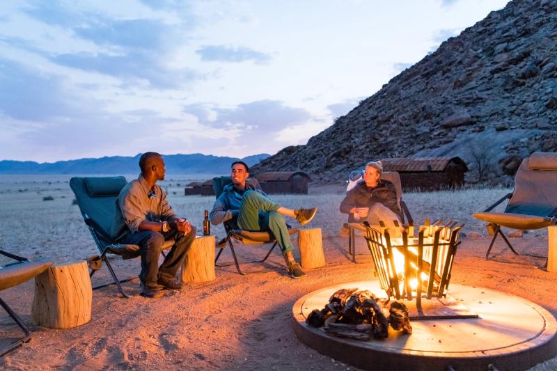 Gathering around the campfire in Namibia at Camp Sossus