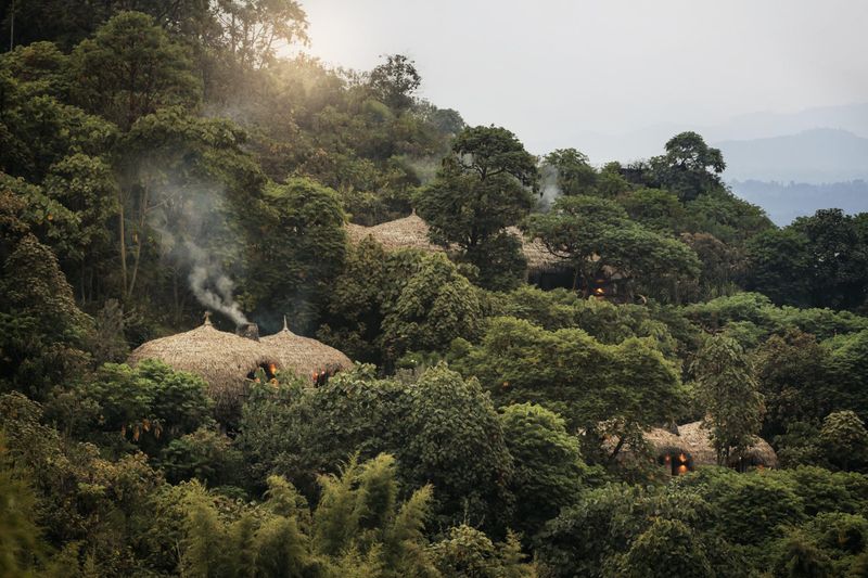 A lodge perched on the slopes of a hill neighboring Volcanoes National Park, as seen on a Rwanda safari