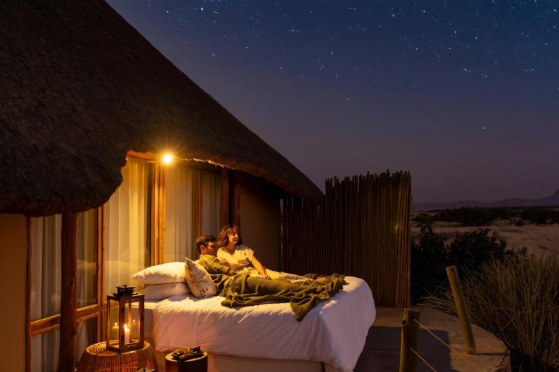 Couple sleeping out under the stars at Doro Nawas