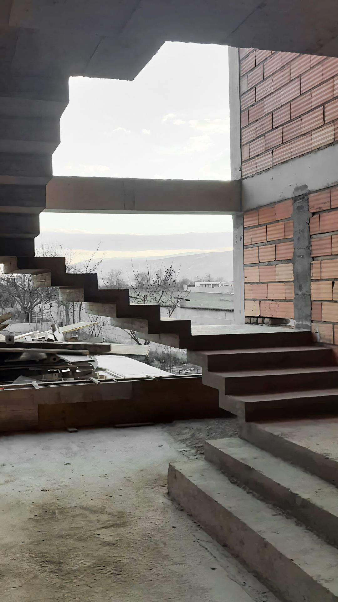 Staircase during construction with brick walls and steel steps, Travertine House in Tetovo