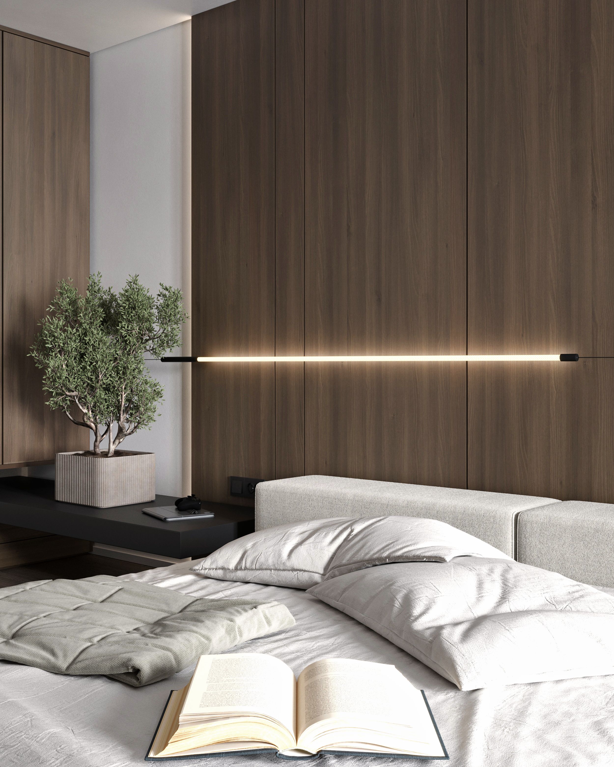 Bed with white linen and an open book, wood wall with light strip, apartment in Skopje