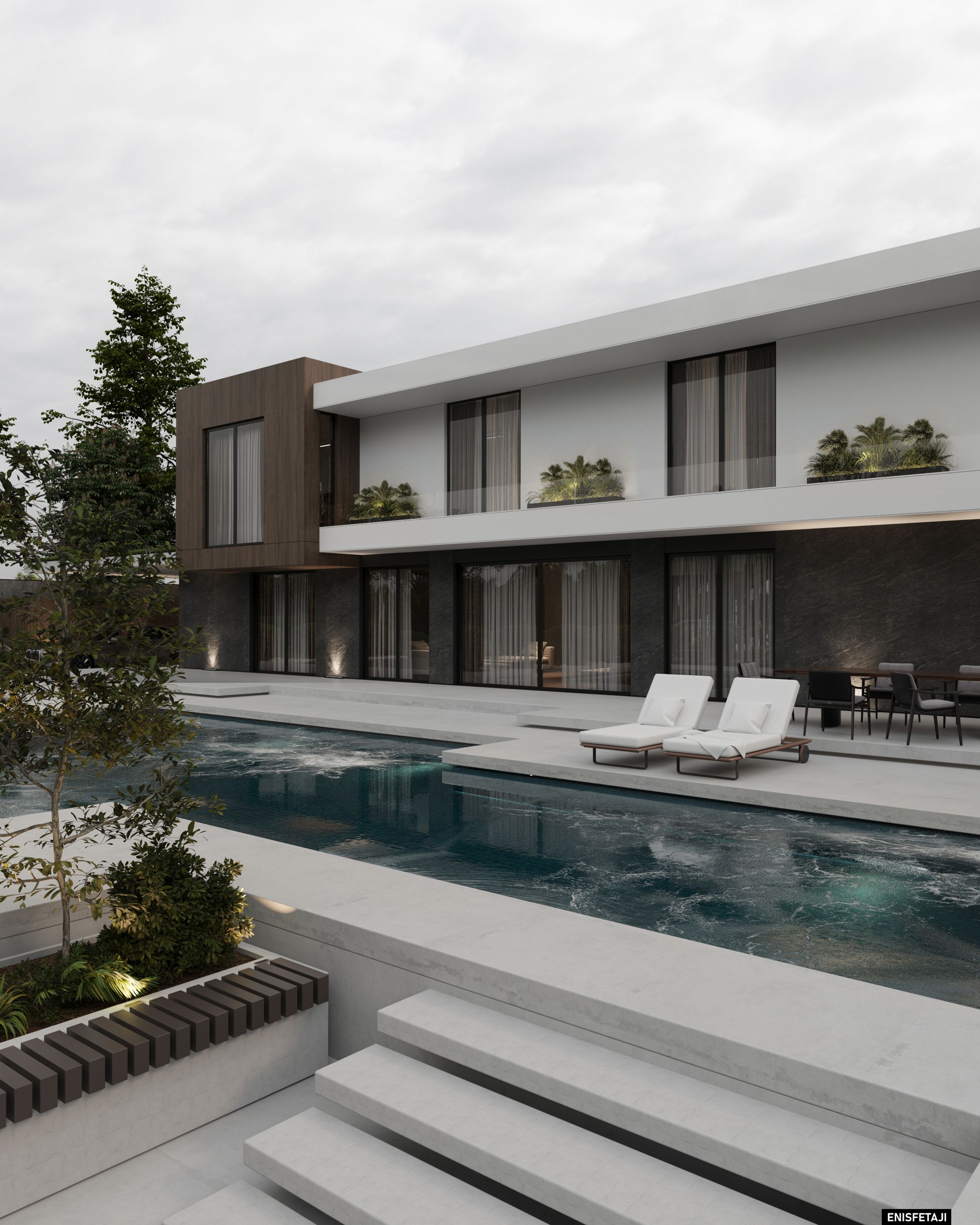 Pool with sun loungers beside a modern two-story villa