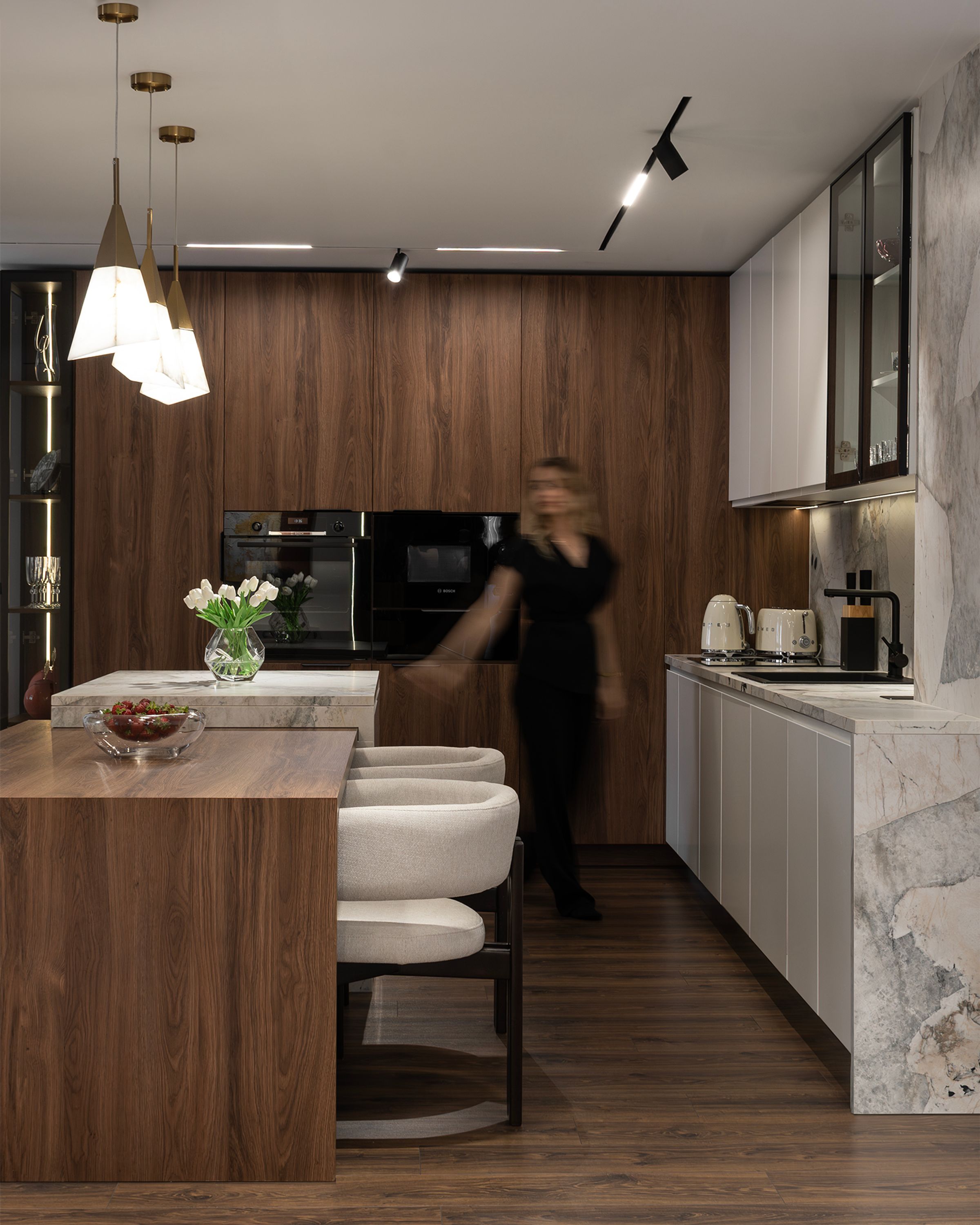 Kitchen with walnut cabinets, marble island and pendant lights, SZ apartment in Gostivar