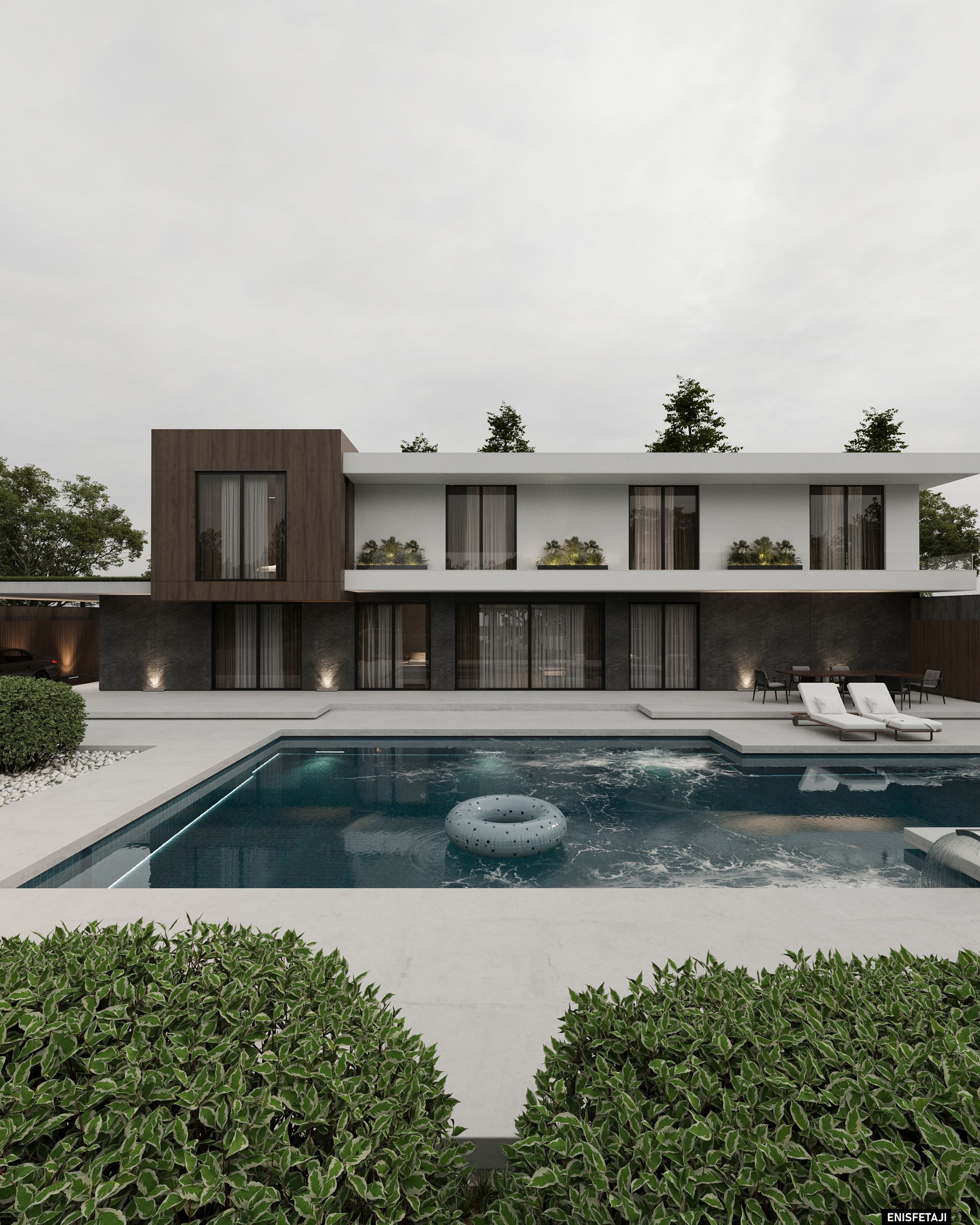 Pool terrace and garden facade of a modern white and wood villa