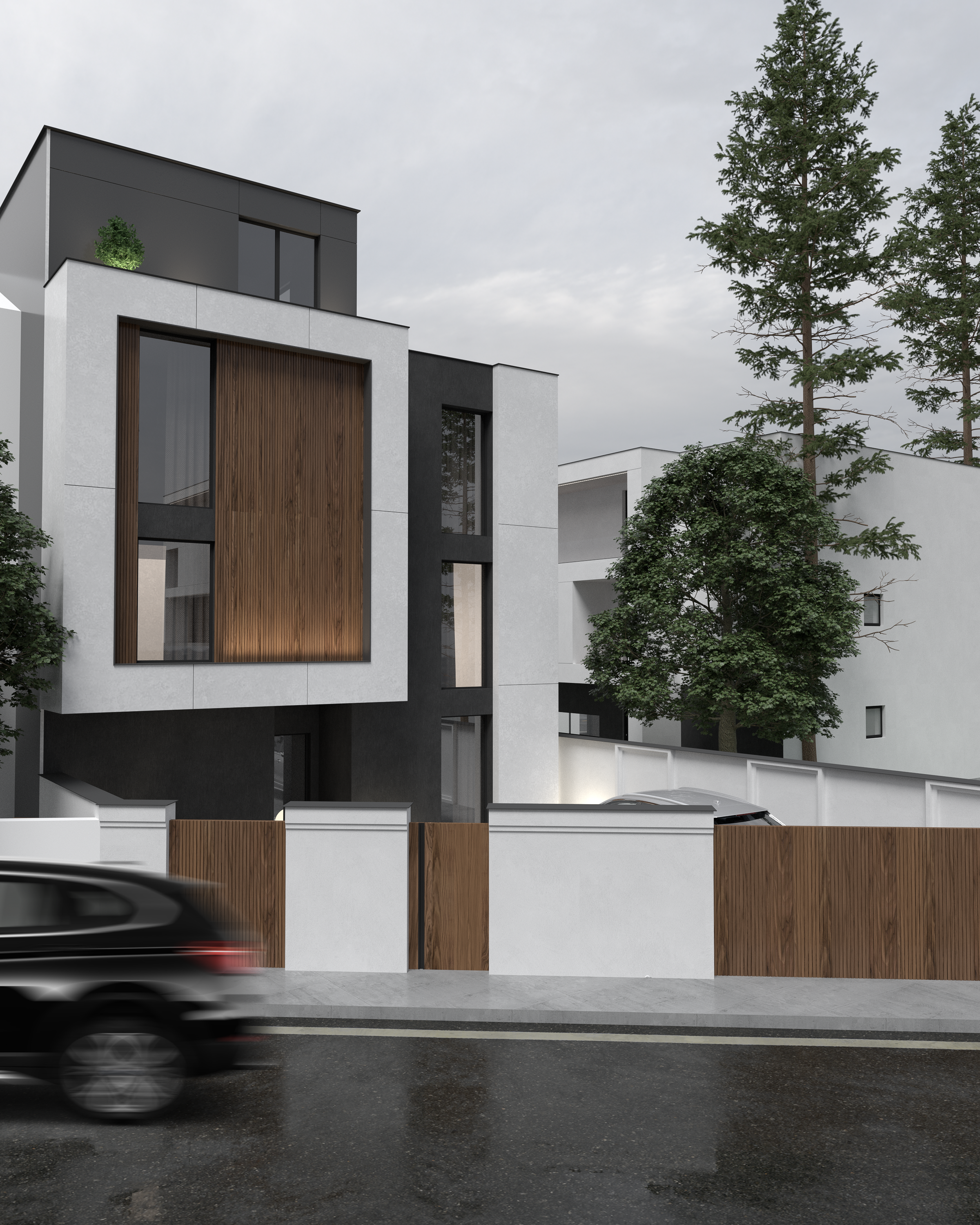 Three-story house seen from the street with white wall and wood gate, Gostivar