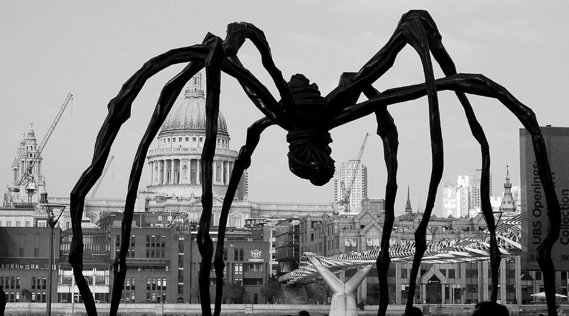Louise Bourgeois' Maman spider sculpture captured in a black and white photograph, with London's St Pauls Cathedral in the background.