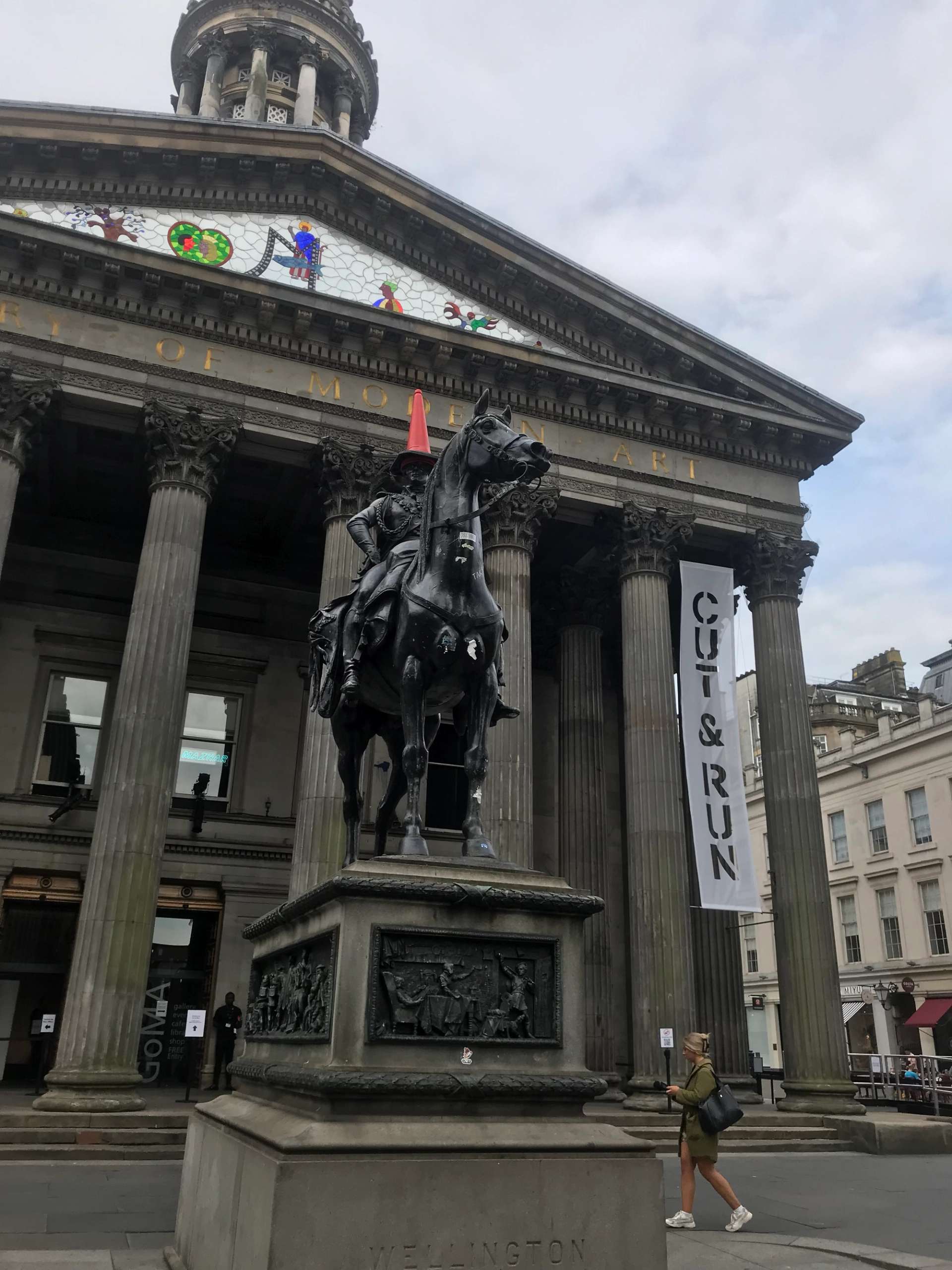 A photograph of the notorious Duke of Wellington statue outside of the GoMA, which has been vandalised with a traffic cone for decades.