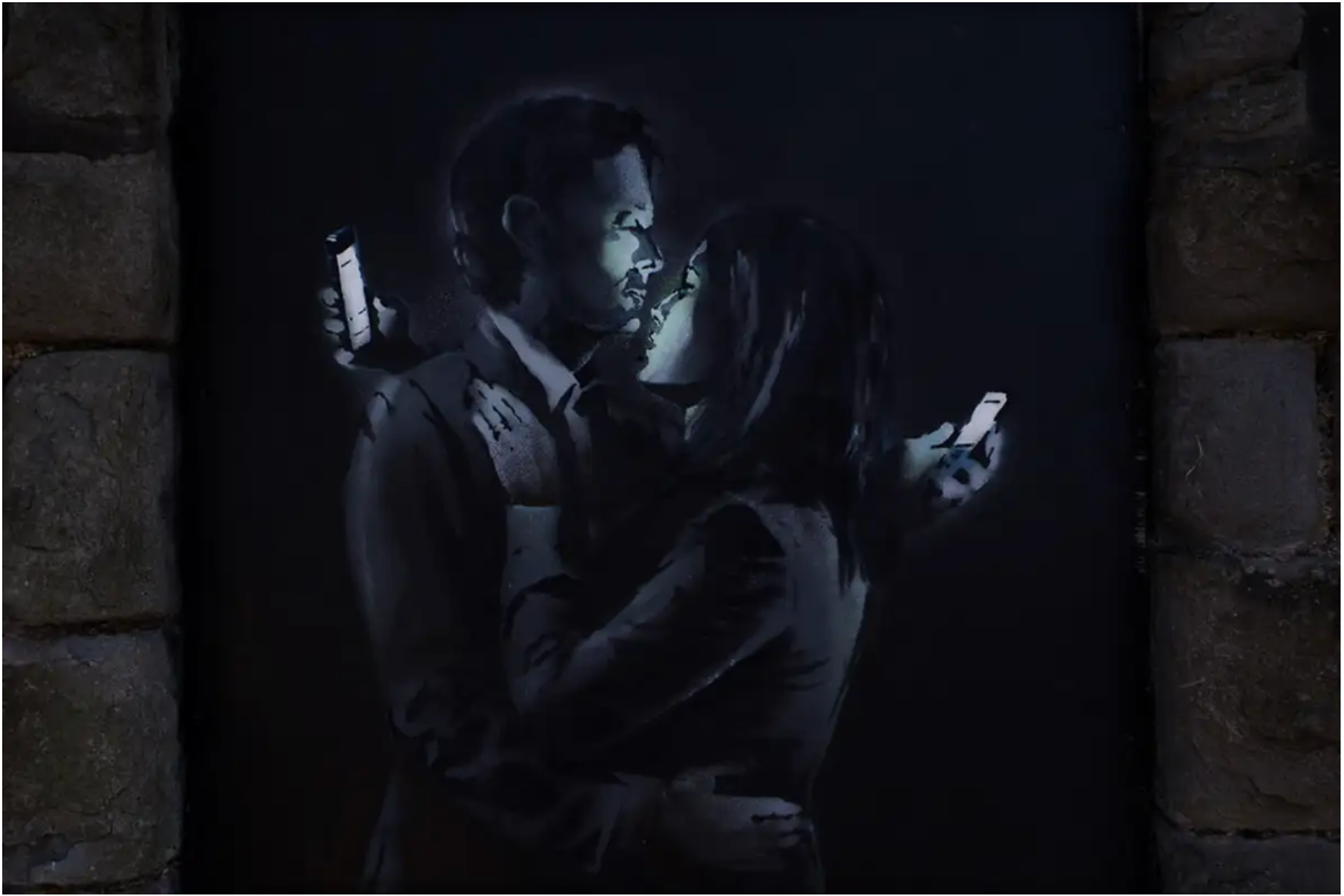  A monochromatic stencil on a wooden panel affixed to a brick wall portrays a couple in an intimate embrace, each fixated on the screen of their phone over the other's shoulder.