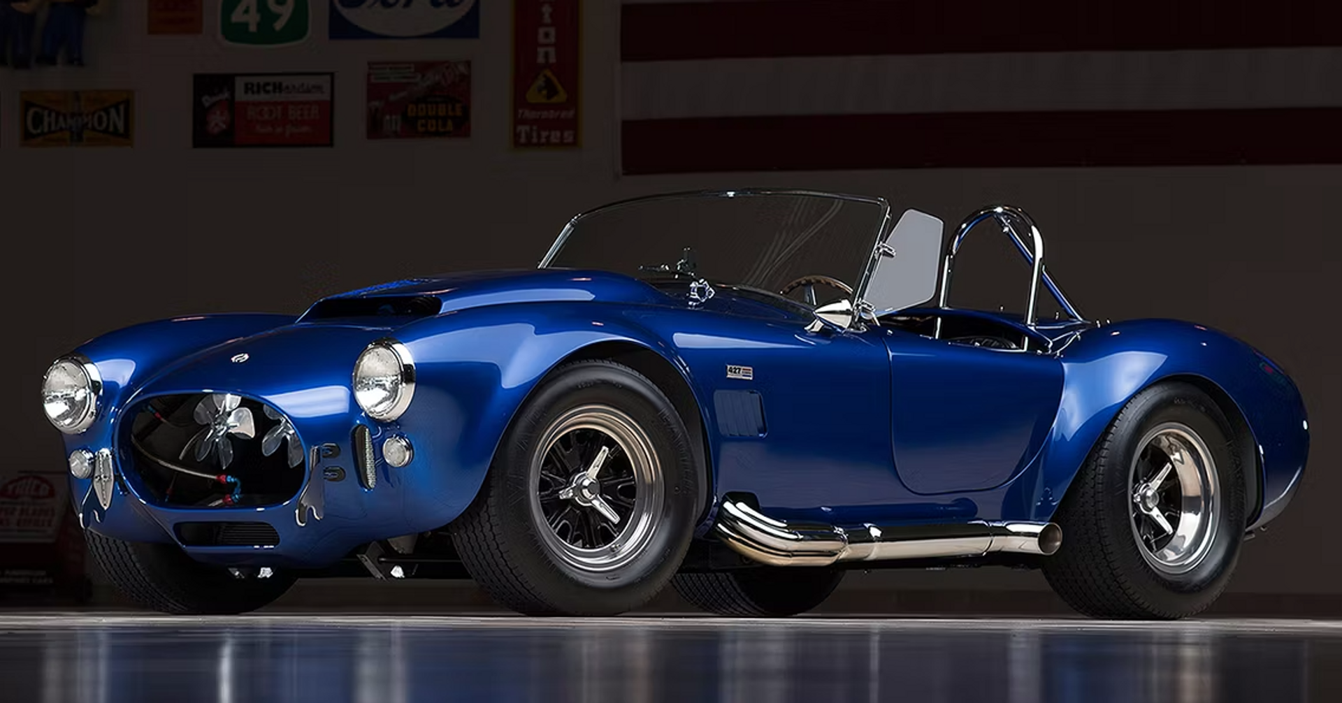 The only 1966 Shelby Cobra 427 ever. The electric blue car is pictured against a dark background.