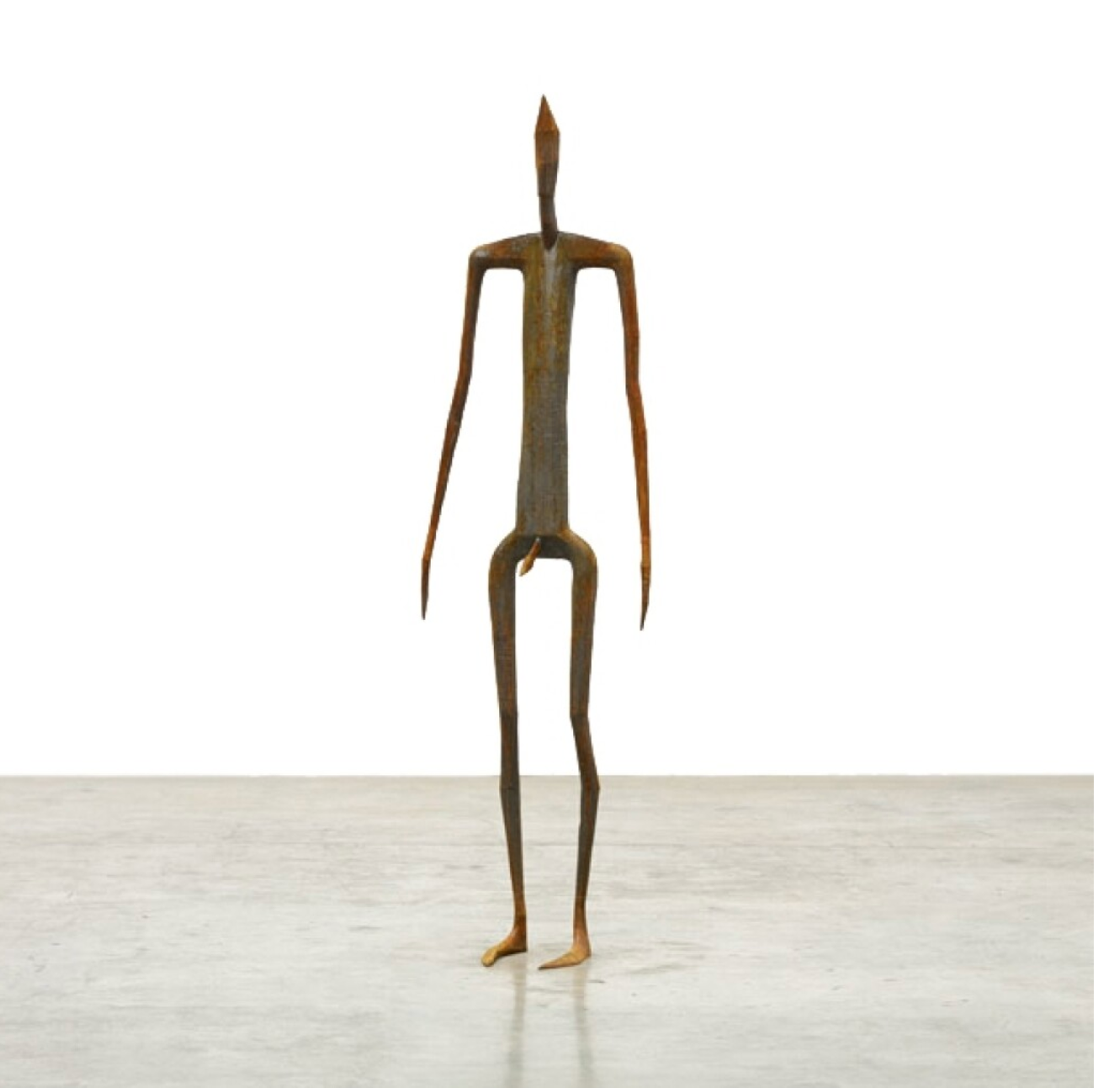 An outline cast iron sculpture of a standing human figure.
