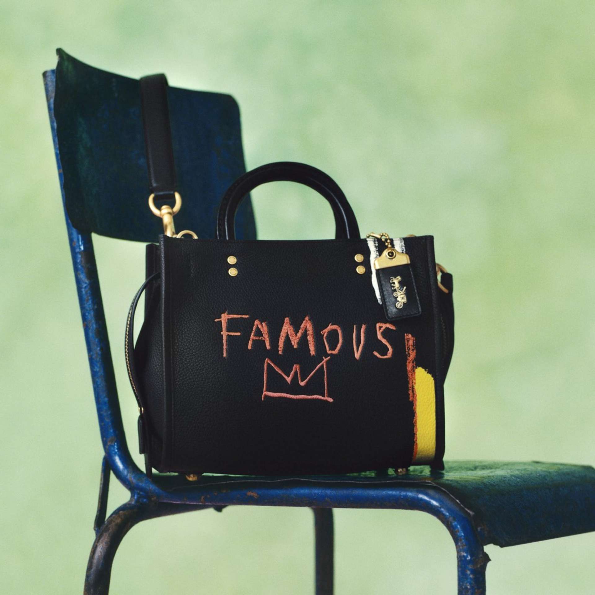 An image of a handbag by brand Coach, featuring Jean-Michel Basquiat’s distinctive crown.